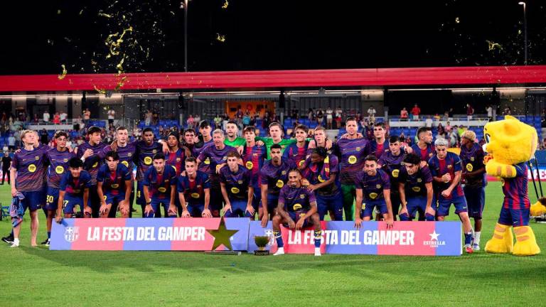 Barcelona players pose with their trophy after winning the 60th Joan Gamper Trophy football match between FC Barcelona and Como 1907 at Johan Cruyff Stadium in Barcelona on August 10, 2025. - AFPPIX