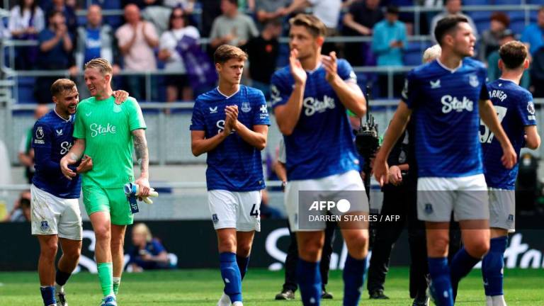 Everton's English midfielder #22 Kiernan Dewsbury-Hall (L) jokes with Everton's English goalkeeper #01 Jordan Pickford after the English Premier League football match between Everton and Brighton and Hove Albion at Hill Dickinson Stadium in Liverpool, north west England on August 24, 2025. - AFP