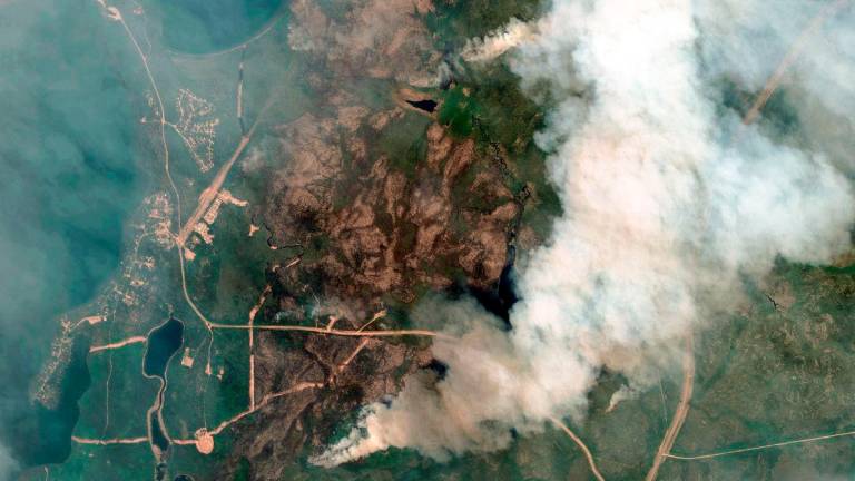 This handout satellite picture courtesy of Maxar Technologies shows an overview of fires at Little Bear Lake, Saskatchewan, Canada on May 30, 2025. AFP PHOTO / HANDOUT / MAXAR TECHNOLOGIES