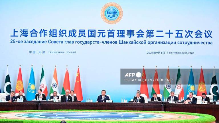 In this pool photograph distributed by the Russian state agency Sputnik, Chinese President Xi Jinping (C) attends the Shanghai Cooperation Organisation (SCO) Summit in Tianjin on September 1, 2025. - Sergey Bobylev / POOL / AFP