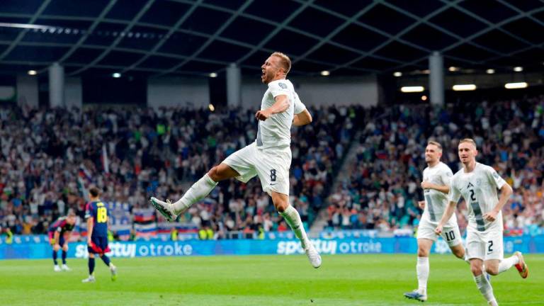 Slovenia’s Sandi Lovric celebrates scoring their first goal with teammates REUTERSPix