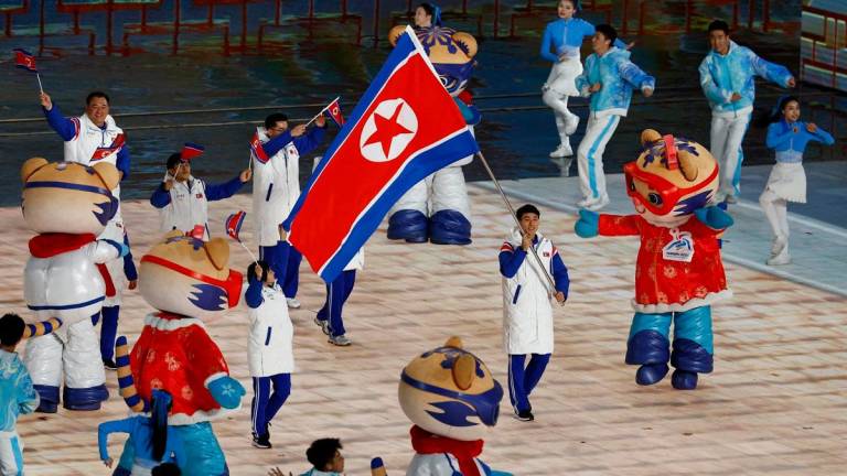 North Korea's flag bearer leads their contingent during the parade of athletes at the opening ceremony of the Harbin 2025 Asian Winter Games in Harbin, northeast China's Heilongjiang province on February 7, 2025. - Issei Kato / POOL / AFP