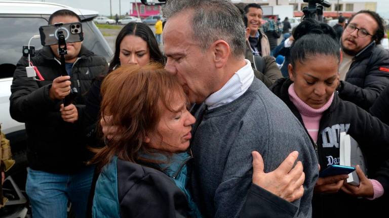 Israel Vallarta hugs his sister Soledad Vallarta (), next to his wife Mary Sainz (R) outside of the Federal Social Readaptation Center No. 1 after spending more than 19 years awaiting sentencing, in the municipality of Almoya de Juarez, State of Mexico. AFPPix