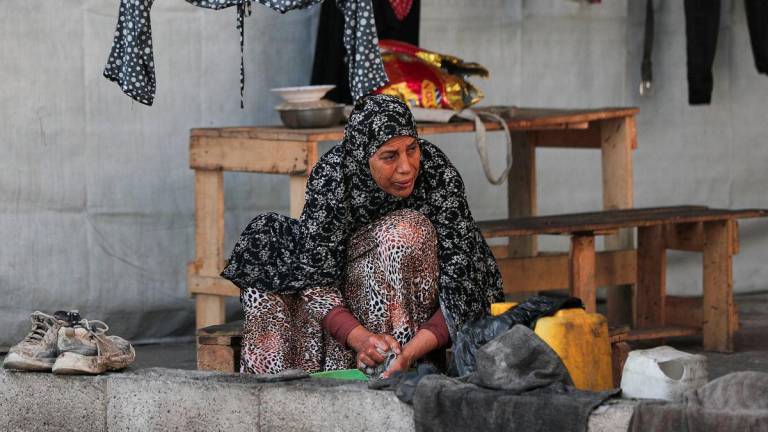 A Palestinian woman displaced by the Israeli military offensive takes shelter in a tent camp, as Israeli forces escalate operations around Gaza City, in Gaza City, September 2, 2025. - REUTERSPIX