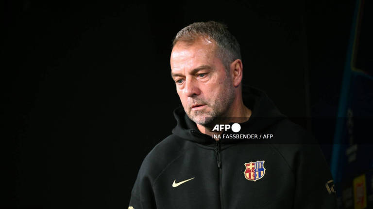 Barcelona's German head coach Hansi Flick arrives for a press conference on the eve of the UEFA Champions League quarter-final second-leg football match BVB Borussia Dortmund v FC Barcelona at the Signal Iduna stadium in Dortmund on April 14, 2025. - AFP