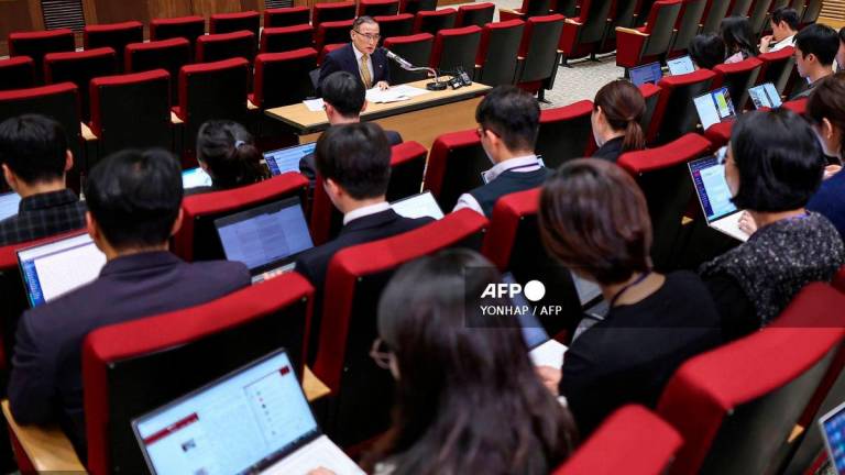 South Korea’s National Security Advisor Wi Sung-lac (C, top) speaks during a press conference at the Presidential Office in Seoul on October 15, 2025. Photo by - / YONHAP / AFP