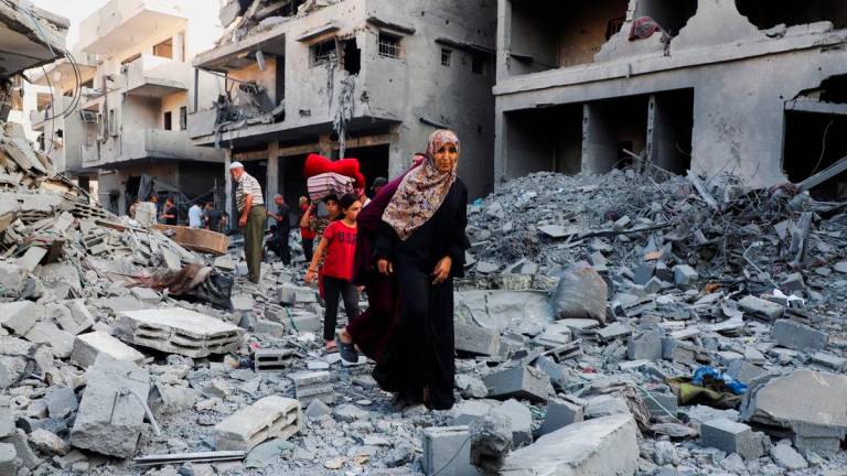 Palestinians inspect the site of an overnight Israeli strike on a house in Gaza City, September 16, 2025. REUTERS/Ebrahim Hajjaj