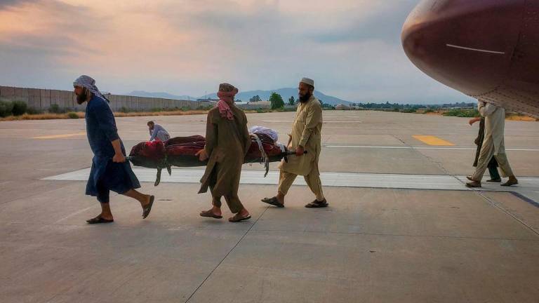 People carry an earthquake victim on a stretcher to an ambulance at an airport in Jalalabad, Afghanistan, September 1, 2025. REUTERS/Stringer