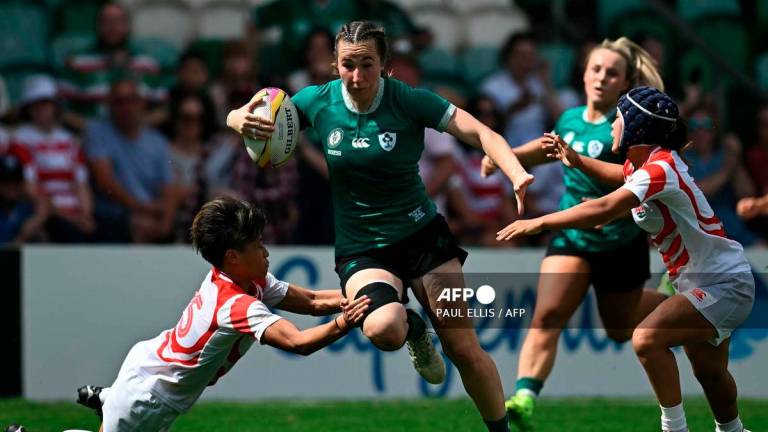 Ireland's centre Eve Higgins (C) breaks through Japan's defence to set up the team's fourth try during the Women’s Rugby World Cup pool C match between Ireland and Japan at Franklin's Gardens in Northampton, central England, on August 24, 2025. - AFP
