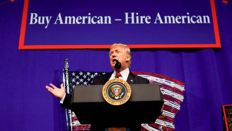 U.S. President Donald Trump speaks before signing an executive order directing federal agencies to recommend changes to a temporary visa program used to bring foreign workers to the United States to fill high-skilled jobs during a visit to the world headquarters of Snap-On Inc, a tool manufacturer in Kenosha, Wisconsin, U.S., April 18, 2017. - REUTERS