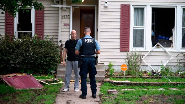Vance Boelter’s roommate, who declined to give his name, speaks with a Minneapolis police officer outside his home on June 14, 2025 in Minneapolis, Minnesota. AFPpix