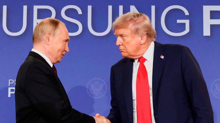 U.S. President Donald Trump and Russian President Vladimir Putin shake hands during a press conference following their meeting to negotiate an end to the war in Ukraine, at Joint Base Elmendorf-Richardson, in Anchorage, Alaska, U.S., August 15, 2025. - REUTERS