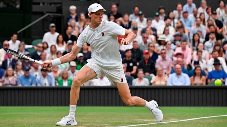 Italy’s Jannik Sinner plays a forehand return to Spain’s Pedro Martinez during their men’s singles third round tennis match on the sixth day of the 2025 Wimbledon Championships at The All England Lawn Tennis and Croquet Club in Wimbledon, southwest London, on July 5, 2025 - AFP