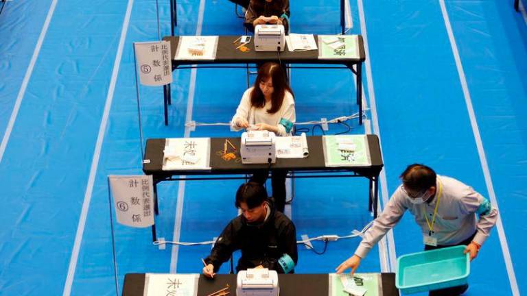 Election officers count ballots for the general election at a ballot counting centre in Tokyo, Japan October 27, 2024. - REUTERSPIX