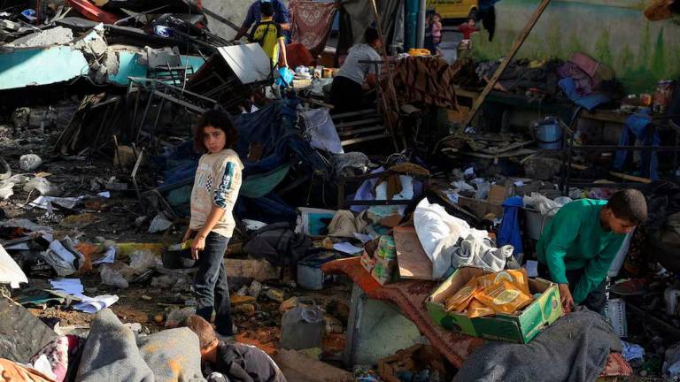 Palestinians inspect the damage at a school sheltering displaced people, following an Israeli strike, in Gaza City, May 26, 2025. REUTERS/Dawoud Abu Alkas/File Photo