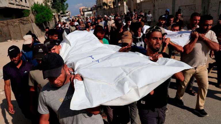 Mourners carry the bodies of Palestinians killed overnight in Israeli attacks on a tent and on people seeking aid, according to Gaza's health ministry, during their funeral, outside Nasser Hospital in Khan Younis, southern Gaza Strip, July 4, 2025. - REUTERSPIX