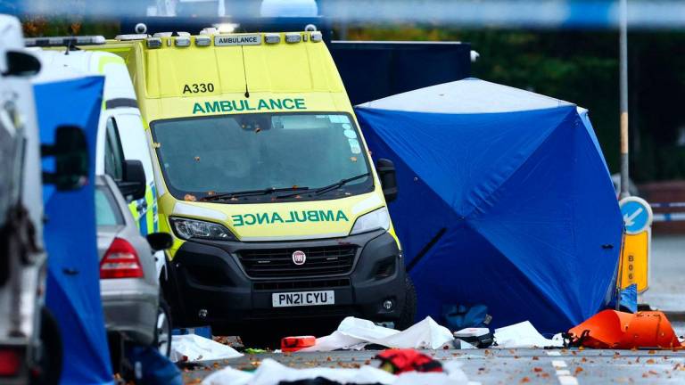 Police tents cover parts of the scene on the main road outside Heaton Park Hebrew Congregation synagogue in Crumpsall, north Manchester, on October 3, 2025, following an attack at the synagogue yesterday. An attacker ploughed a car into a crowd outside a packed synagogue in Britain on Thursday, a Jewish holiday, before going on a stabbing spree, killing two people and leaving three wounded, police said. (Photo by Paul Currie / AFP)