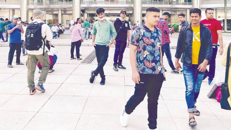 Foreign workers enjoying a day out in Kuala Lumpur. Khairul said although he sometimes faces discrimination, he has met many Malaysians who are kind. – ADIB RAWI YAHYA/THESUN