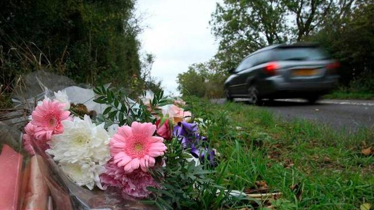 Above, floral tributes lay on the roadside near RAF Croughton in Northamptonshire, central England on Oct. 10, 2019, at the spot where teenager Harry Dunn was killed. (AFP file photo)