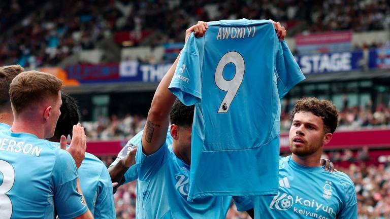 Football - Premier League - West Ham United v Nottingham Forest - London Stadium, London, Britain - May 18, 2025Nottingham Forest's Morgan Gibbs-White celebrates scoring their first goal with a shirt in support of their injured teammate Taiwo Awoniyi - REUTERSPIX