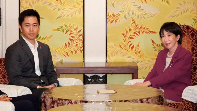 Liberal Democratic Party (LDP) President Sanae Takaichi (R) and head of the major opposition Japan Innovation Party Hirofumi Yoshimura. - AFPpix