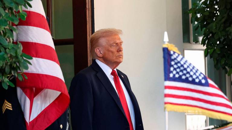 U.S. President Donald Trump waits for Australia’s Prime Minister Anthony Albanese’s arrival at the White House in Washington, D.C., U.S. October 20, 2025. REUTERS/Kevin Lamarque