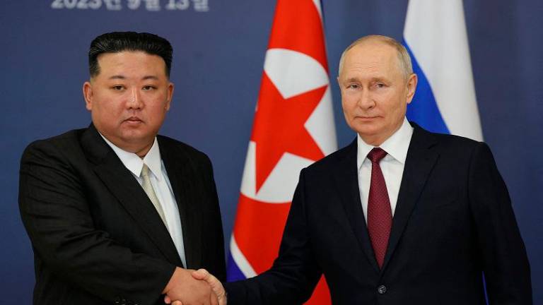 This pool image distributed by Sputnik agency shows Russian President Vladimir Putin (R) and North Korea’s leader Kim Jong Un (L) shaking hands during their meeting at the Vostochny Cosmodrome in Amur region on September 13, 2023, ahead of planned talks that could lead to a weapons deal with Russian President. (Photo by Vladimir SMIRNOV / POOL / AFP)