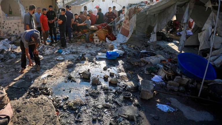 Palestinians inspect the damage at the site of an overnight Israeli strike on a tent sheltering displaced people, in Gaza City - Reuterspix