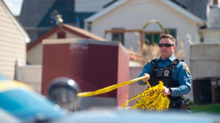 Police officers from the Falls Township Police Department tape off and inspect the scene of one of three shootings in the Vermillion Hills neighborhood on March 16, 2024 in Levittown, Pennsylvania/AFPPix