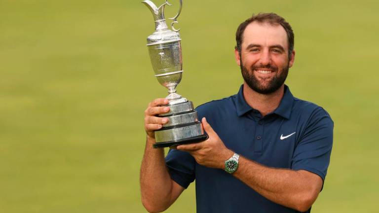 Scottie Scheffler celebrates with the Claret Jug after winning the 153rd Open Championship golf tournament at Royal Portrush. Mike Frey-Imagn Images