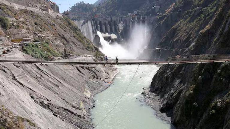 Labourers walk on a bridge near the 450-megawatt hydropower project located at Baglihar Dam on the Chenab river which flows from Indian Kashmir into Pakistan, at Chanderkote, about 145 km (90 miles) north of Jammu - REUTERSpix