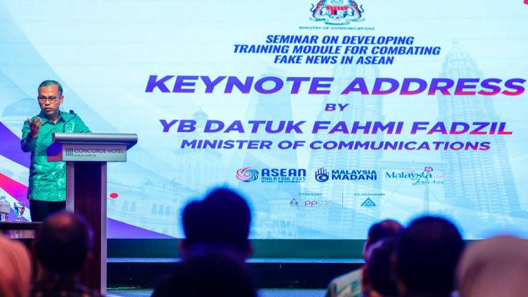 Minister of Communications, Datuk Fahmi Fadzil, delivering his keynote address while officiating the “Seminar on Developing Training Module for Combating Fake News in ASEAN 2025” today.