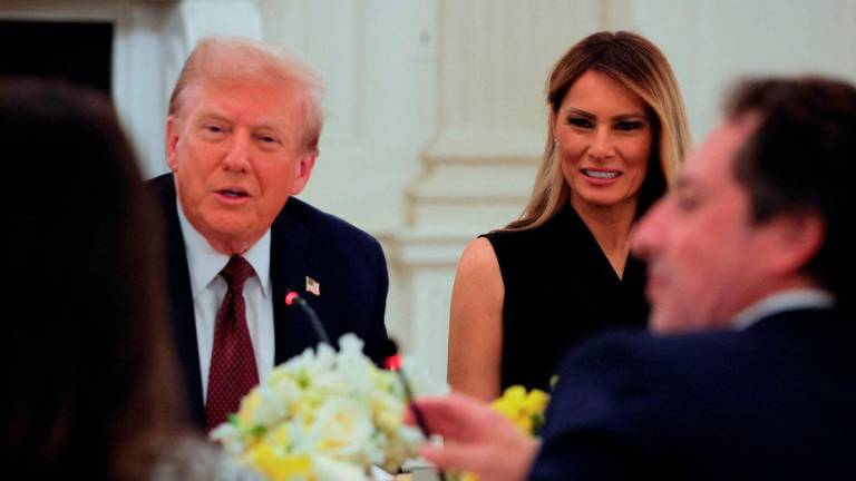 U.S. President Donald Trump and first lady Melania Trump attend a private dinner for technology and business leaders in the State Dining Room at the White House in Washington, D.C., U.S., September 4, 2025. REUTERS/Brian Snyder