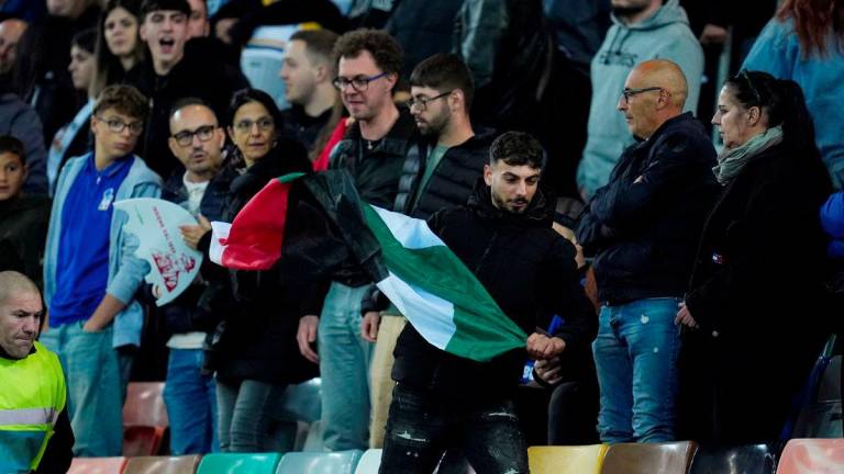 Football - FIFA World Cup - UEFA Qualifiers - Group I - Italy v Israel - Bluenergy Stadium, Udine, Italy - October 14, 2025A fan waving a Palestinian flag is chased by a steward in the stands - REUTERSPIX