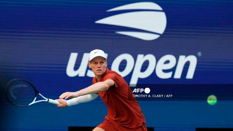 Italy's Jannik Sinner plays a shot to Canada’s Denis Shapovalov during their men's singles third round match on day seven of the US Open tennis tournament at the USTA Billie Jean King National Tennis Center in New York City, on August 30, 2025. - AFP