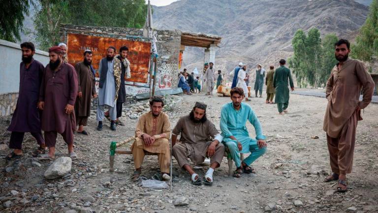 Victims of a deadly magnitude-6 earthquake that struck Afghanistan on Sunday, wait outside a mobile clinic setup inside a school, in Nurgal district, Kunar province, Afghanistan, September 3, 2025. REUTERS/Sayed Hassib