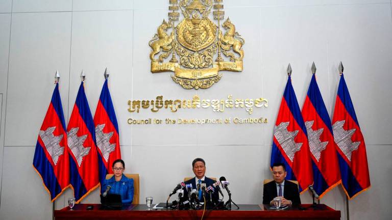 Sun Chanthol (C), Cambodia’s deputy prime minister and first vice-chairman of the Council for the Development of Cambodia (CDC), speaks during a press conference at CDC building in Phnom Penh on August 1, 2025. Cambodian Prime Minister Hun Manet on August 1 welcomed a 19 percent trade tariff imposed by US President Donald Trump, avoiding a threatened levy of 36 percent -Photo by TANG CHHIN Sothy / AFP