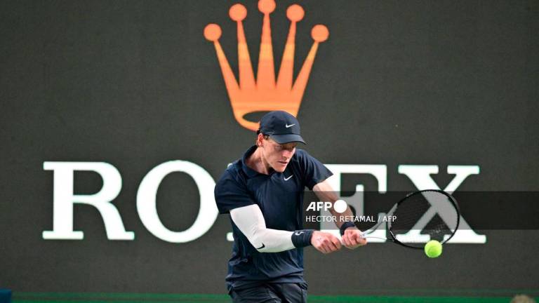 Italy's Jannik Sinner plays a backhand return to Netherlands' Tallon Griekspoor during their men's singles match at the Shanghai Masters tennis tournament in Shanghai on October 5, 2025. - AFP