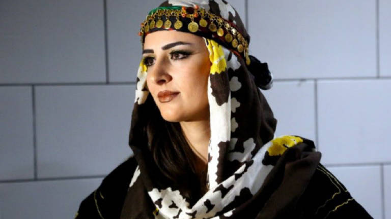 Syria's Kurds hit catwalk to promote traditional attire
