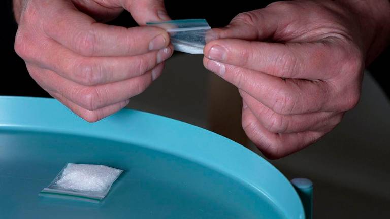 A still image taken from AFPTV shows a dealer holding a bag of ketamine in London on June 19, 2025. AFPPIX