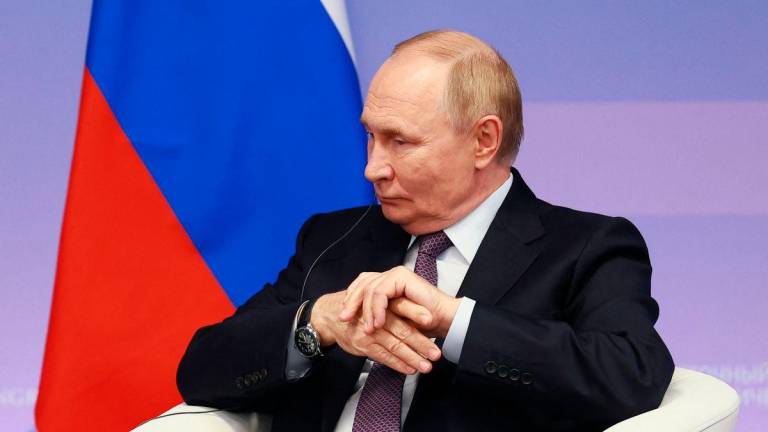 In this pool photograph distributed by the Russian state agency Sputnik, Russia’s President Vladimir Putin attends a meeting with First Vice Chairman of the Standing Committee of the National People’s Congress (NPC) on the sidelines of the Eastern Economic Forum in Vladivostok on September 5, 2025. (Photo by Vladimir SMIRNOV / POOL / AFP)