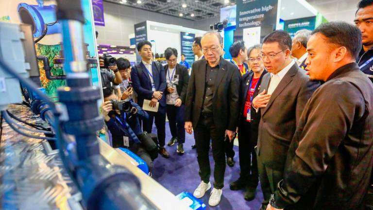 Nga being accompanied by CIS Network president Datuk Vincent Lim during a tour of the exhibits at the Urban Engineering Symposium yesterday. – Adam Amir Hamzah /theSun