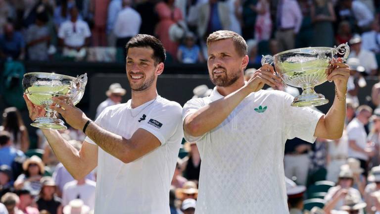 Tennis - Wimbledon - All England Lawn Tennis and Croquet Club, London, Britain - July 12, 2025Britain's Lloyd Glasspool and Julian Cash pose with their trophies after winning the men's doubles final against Australia's Rinky Hijikata and Netherlands' David Pel - REUTERSPIX