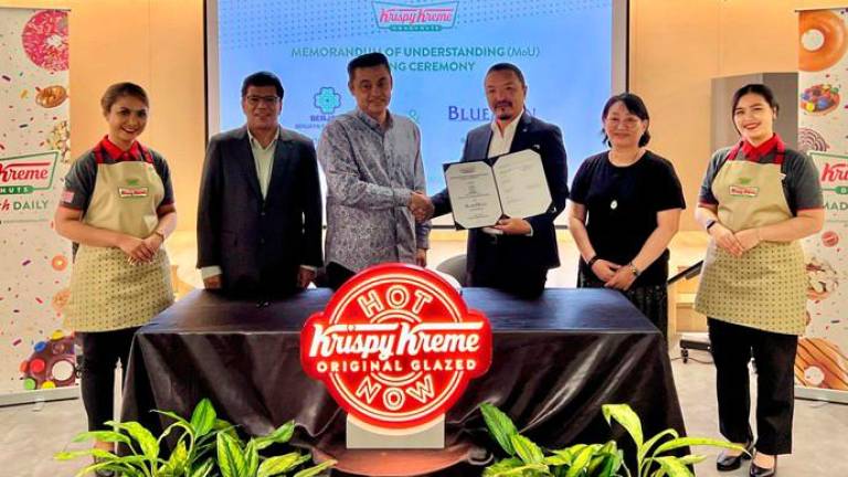 From left: Berjaya Food International director Luis Daniel, Quays, Tseveen-Ochir and BlueMon chief financial officer and food &amp; beverage head Tsogzul Bold at the MoU signing ceremony.