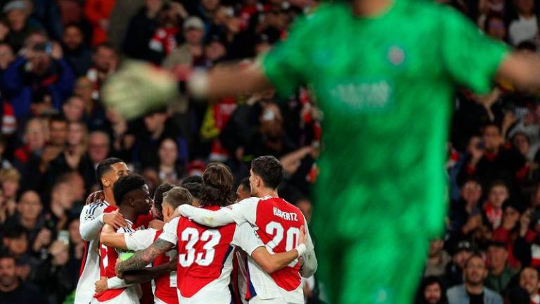 Arsenal’s midfielder Bukayo Saka is mobbed by teammates after scoring the team’s second goal - AFPpix