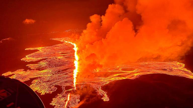 This handout picture released by the Icelandic Coast Guard on March 16, 2024 shows billowing smoke and flowing lava pouring out of a new fissure during a new volcanic eruption on the outskirts of the evacuated town of Grindavik, western Iceland/AFPPix