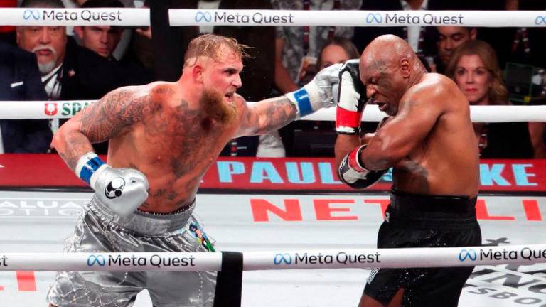 Mike Tyson (black gloves) fights Jake Paul (silver gloves) at AT&amp;T Stadium - REUTERSpix