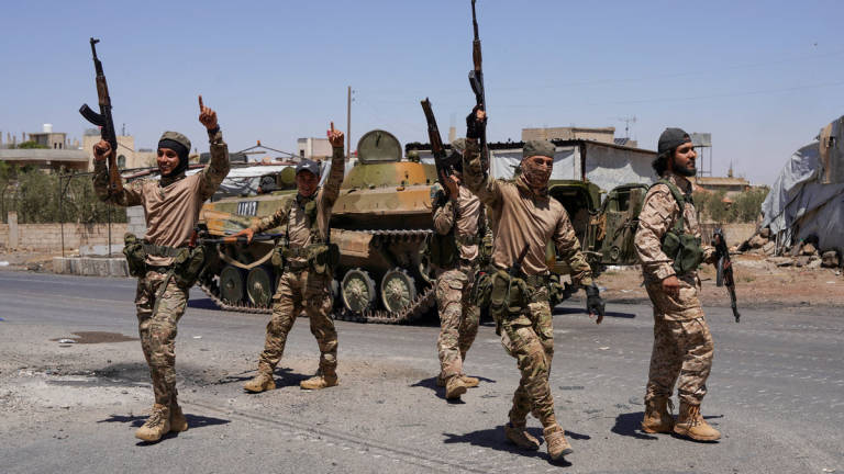 Syrian security forces walk together along a street, after clashes between Syrian government troops and local Druze fighters resumed in the southern Druze city of Sweida early on Wednesday, collapsing a ceasefire announced just hours earlier that aimed to put an end to days of deadly sectarian bloodshed, in Sweida, Syria July 16, 2025. - REUTERS