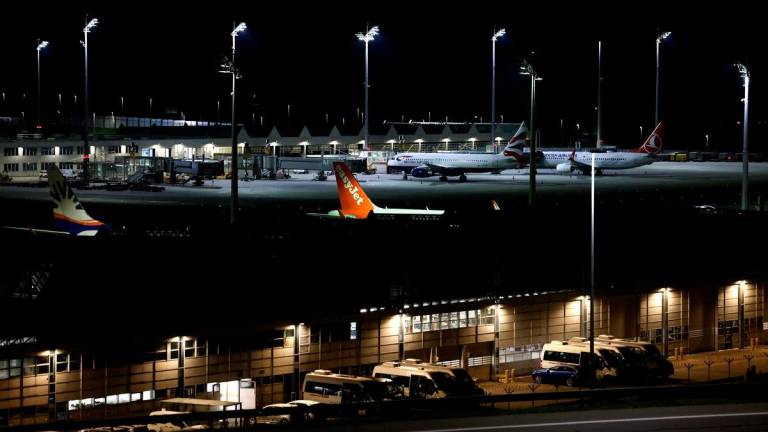 Night view shows a plane of airline EasyJet among others grounded at Munich International Airport in Munich, southern Germany, on early October 4, 2025, after reports of drone sightings again forced Munich airport to close and more than 30 flights had to be cancelled and left nearly 3,000 passengers stranded. (Photo by Michaela STACHE / AFP)