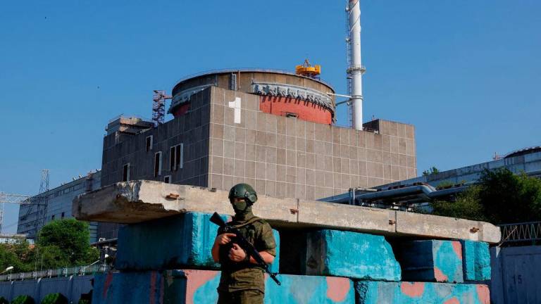 A Russian service member stands guard at a checkpoint near the Zaporizhzhia Nuclear Power Plant - REUTERSPIX